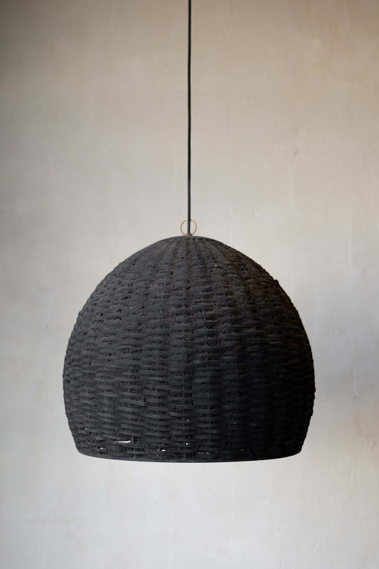 Black Woven Beehive Pendant hanging with white wall background.