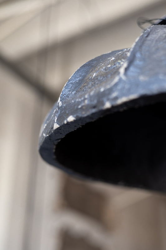 Close-up of a pendant light with a blurred background.