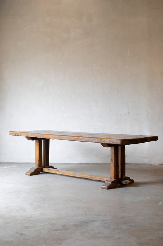 Wooden table against a plain wall