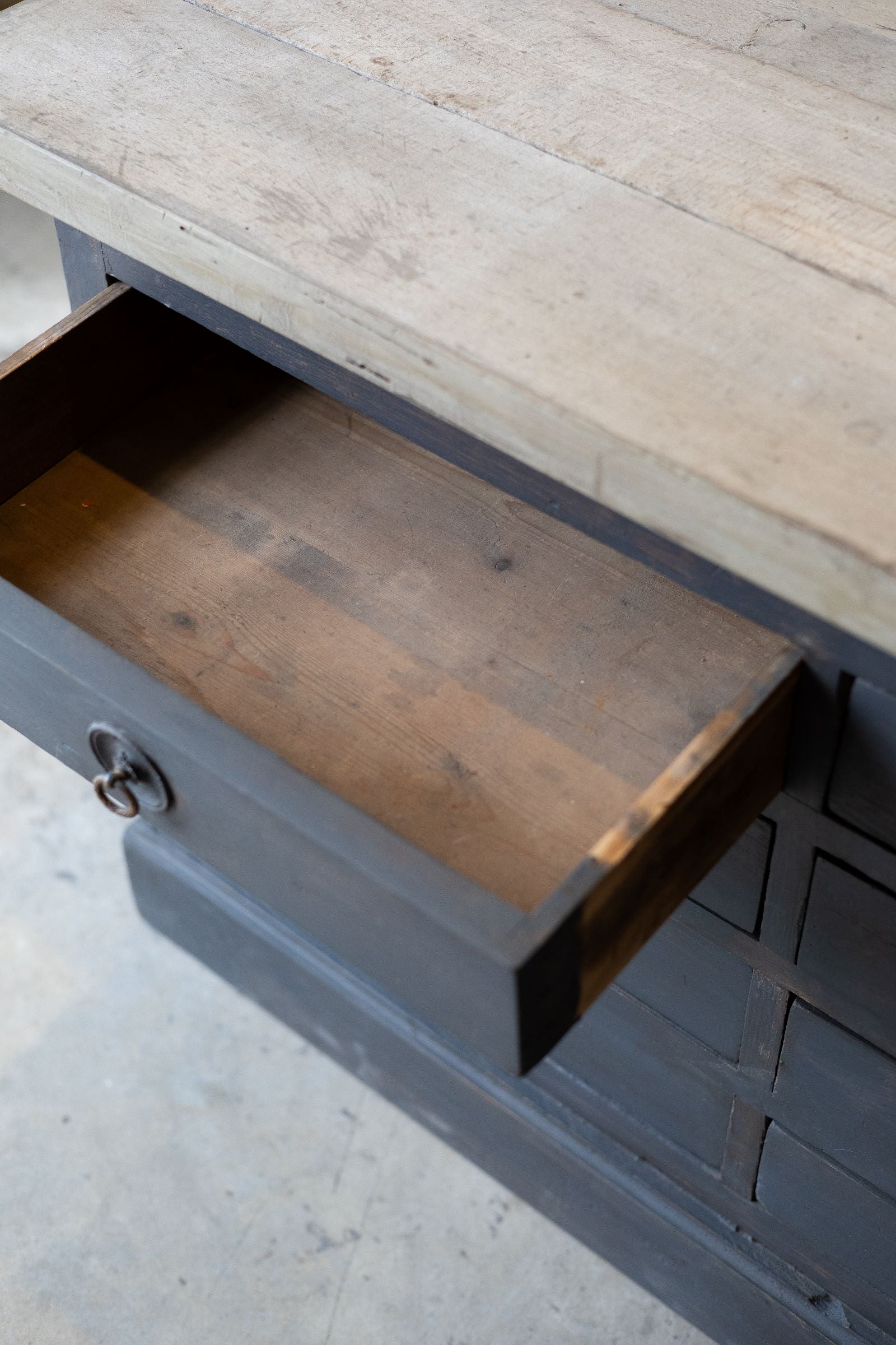 Wooden drawer of dark wood sideboard. 