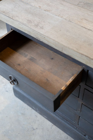 Wooden drawer of dark wood sideboard. 