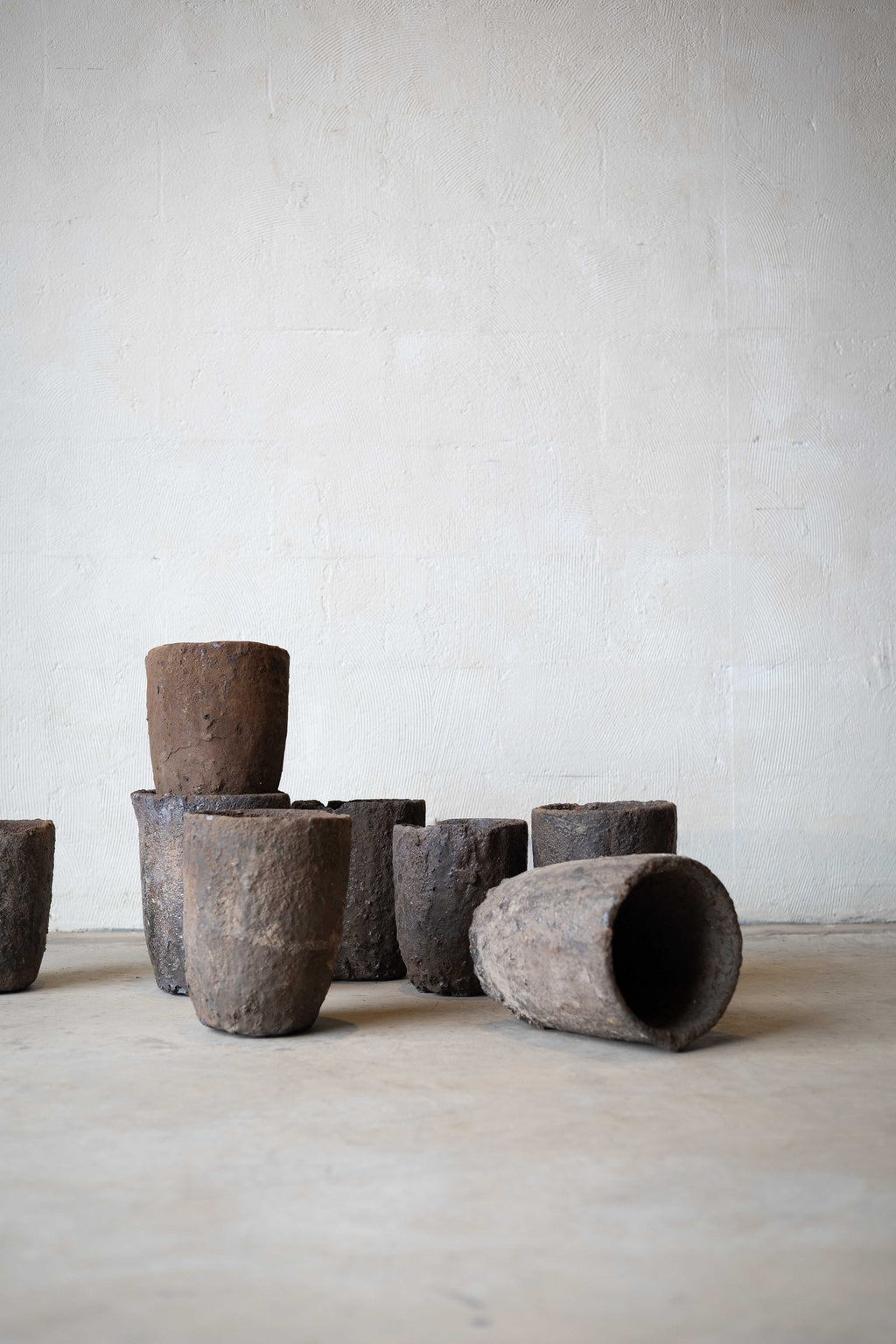 Group of iron crucibles with one tipped over. 