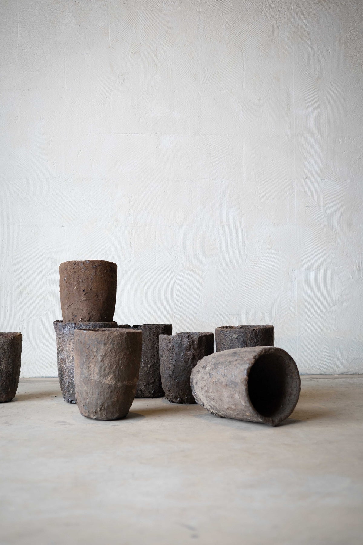 Group of iron crucibles with one tipped over. 