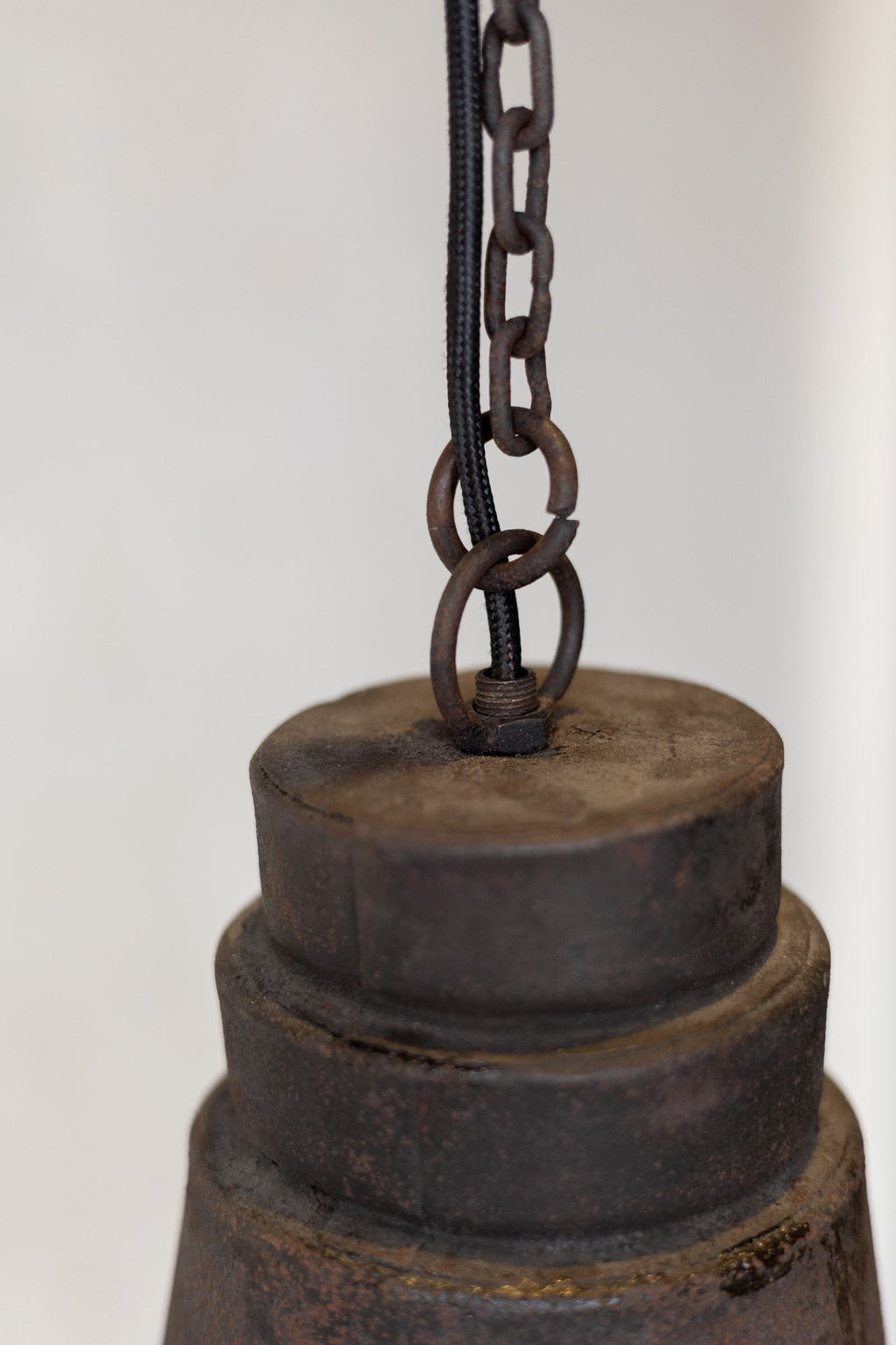 Close up of antique industrial pendant light chord and chain. 