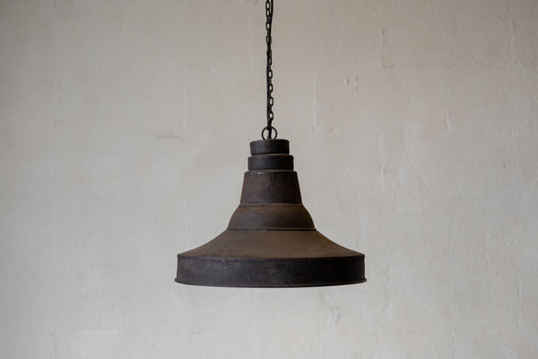 Wide image of antique industrial pendant light against white background. 