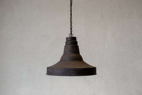 Wide image of antique industrial pendant light against white background. 