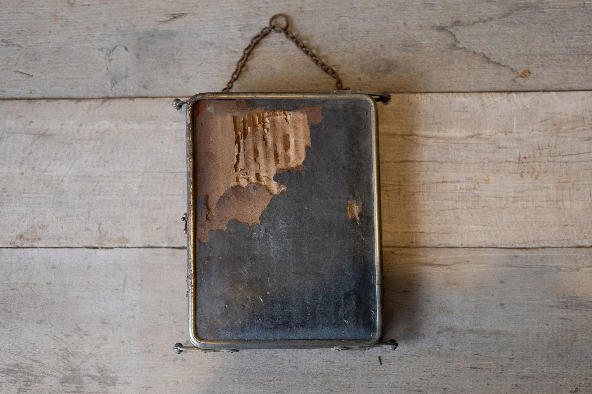 Back of barber mirror panel showing ware one cardboard back. 
