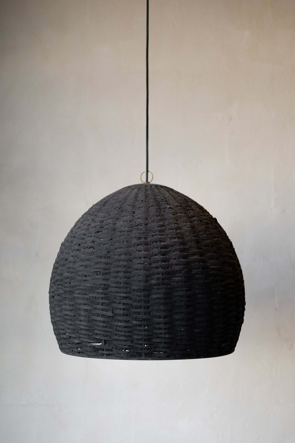 Black Woven Beehive Pendant hanging with white wall background.  Main image