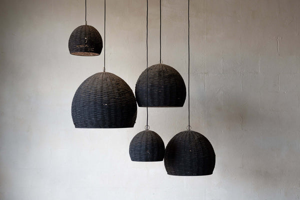Group of five beehive pendant lights hanging at different heights with different sizes. 