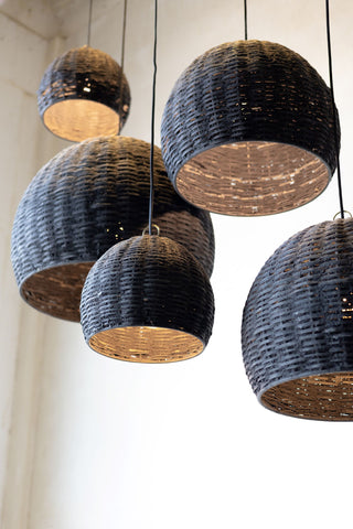 Group of five beehive pendant lights hanging at different heights with different sizes from low angle. 
