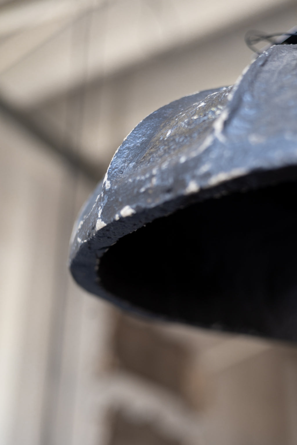 Close-up of a pendant light with a blurred background.