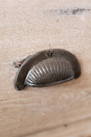 Semi-circular metal handle of Bombay cabinet.