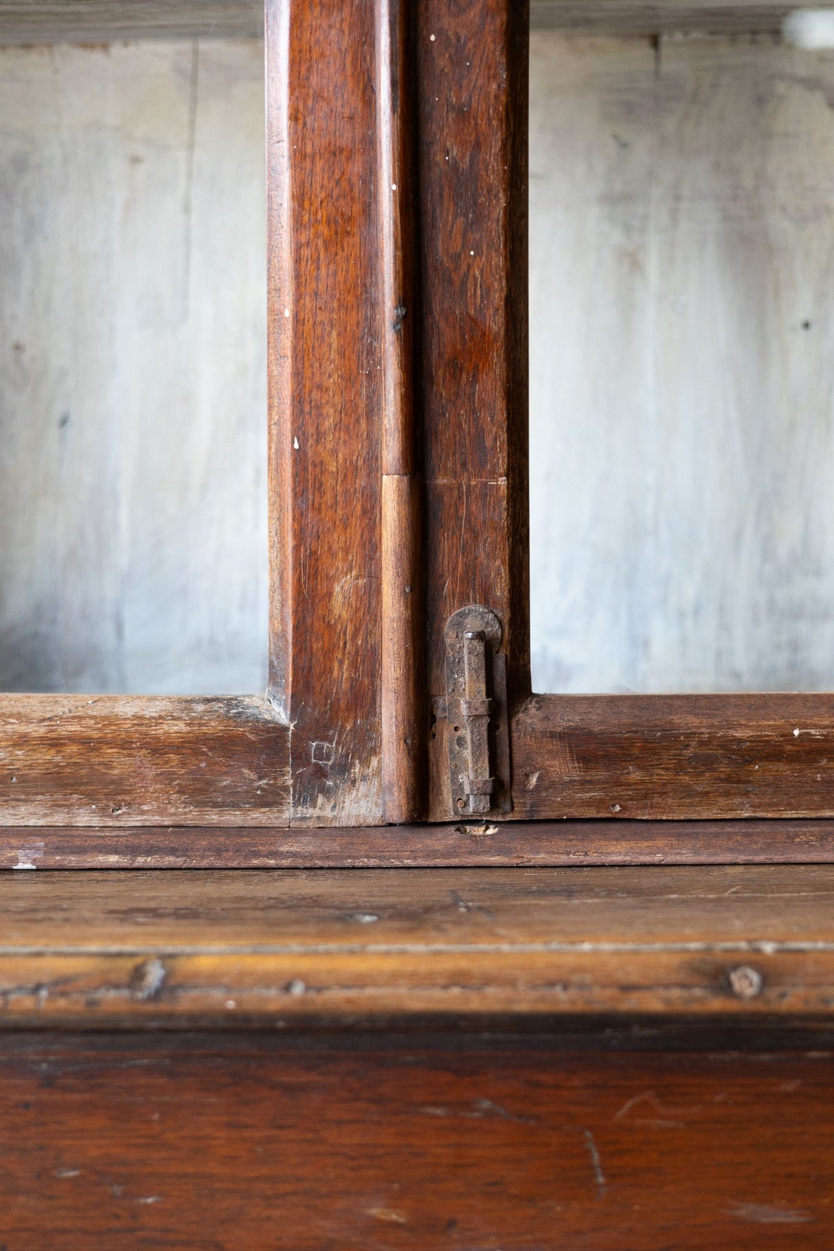 Close-up of an old wooden bookcase door with glass panes.