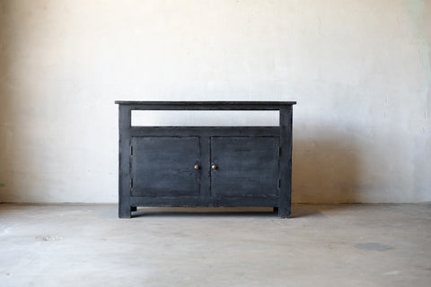 Dark wooden console sideboard against a plain wall.