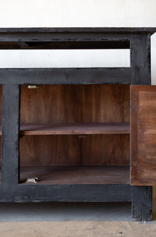 Black wooden console cabinet with unpainted interior and black painted wooden exterior. 
