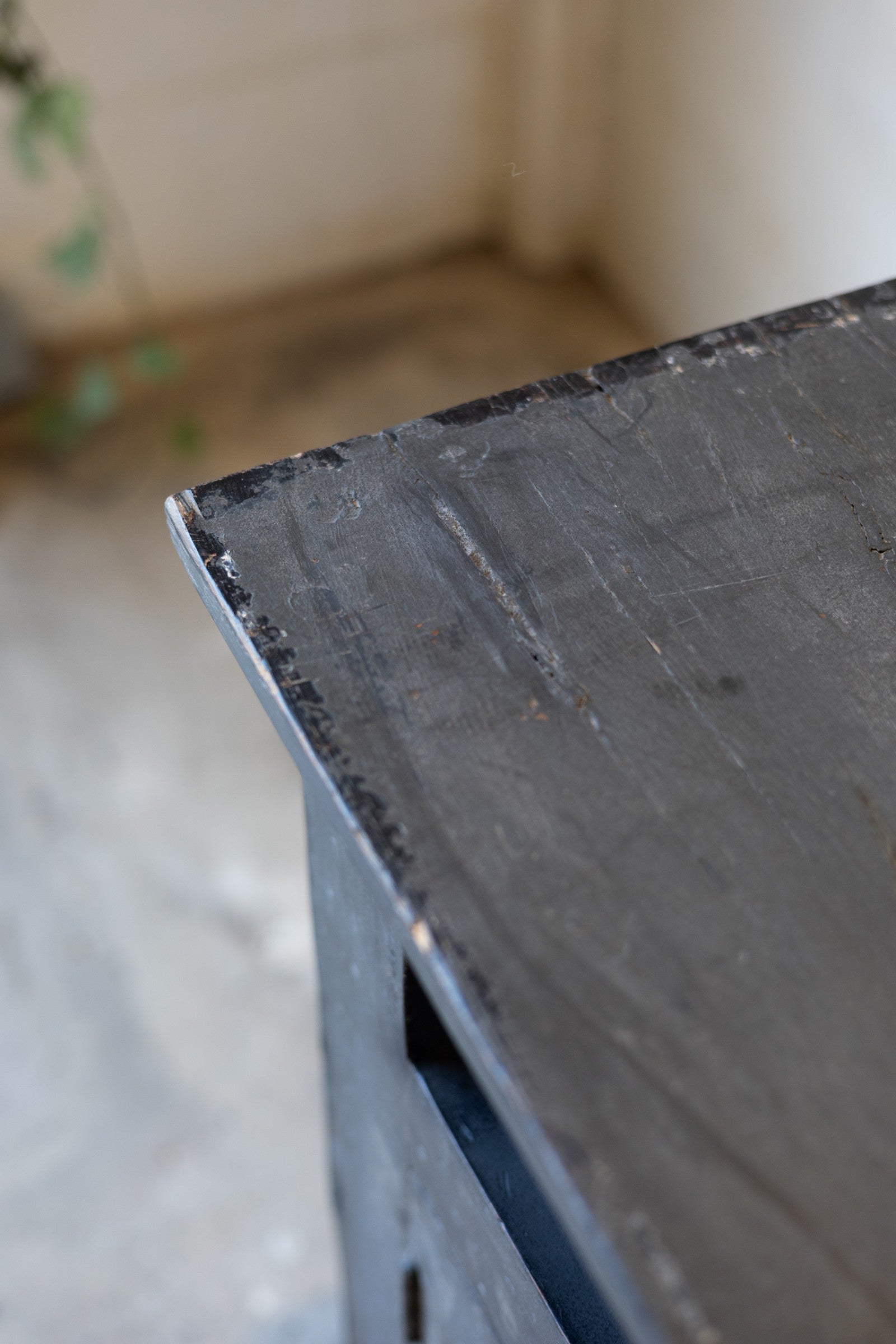 Close-up of a dark wooden table top of console with a blurred background.