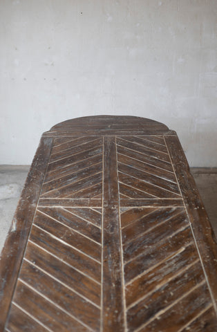 Wooden surface with a chevron pattern on a plain background