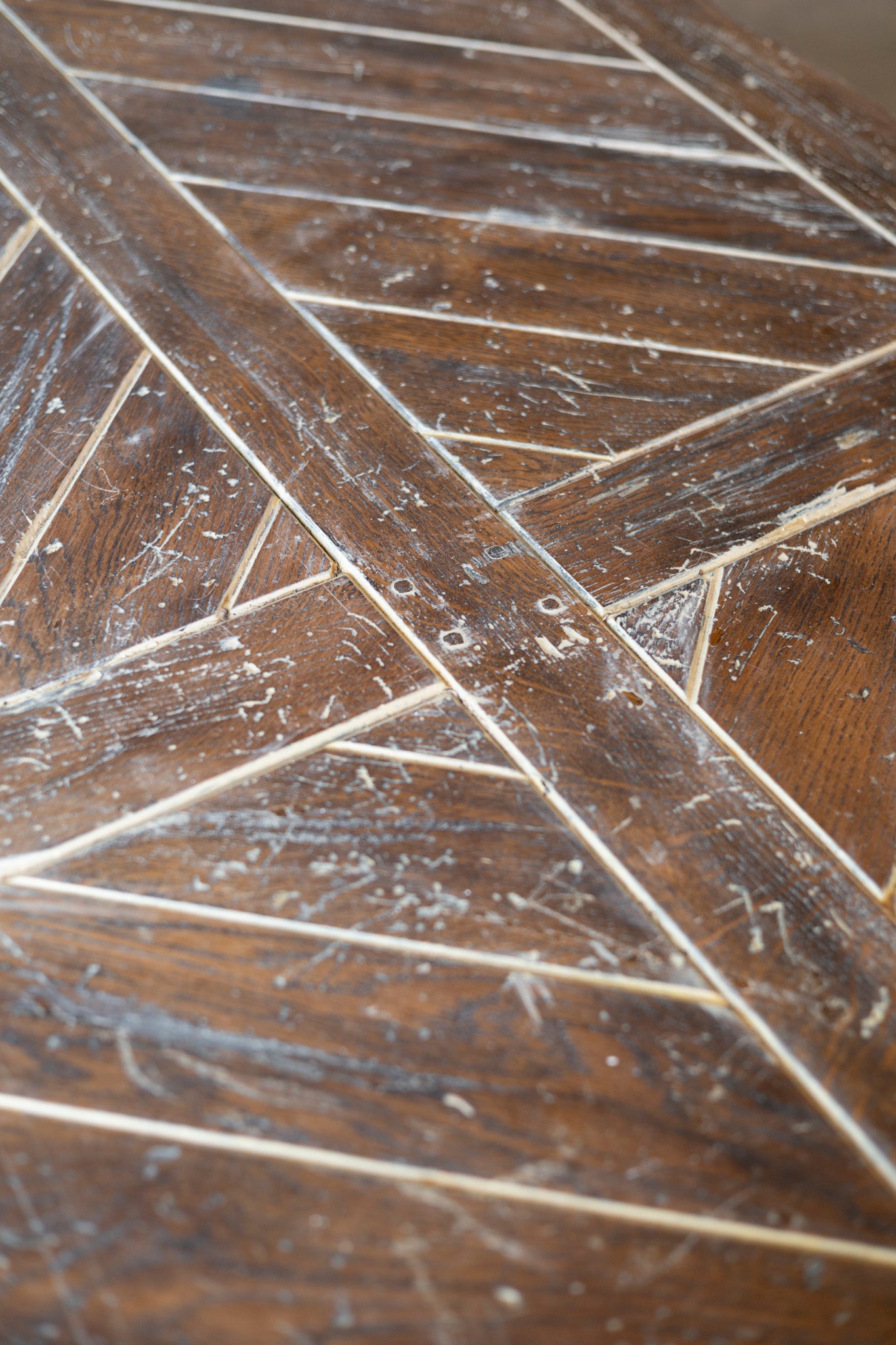 Close-up of a wooden surface with engraved lines and numbers