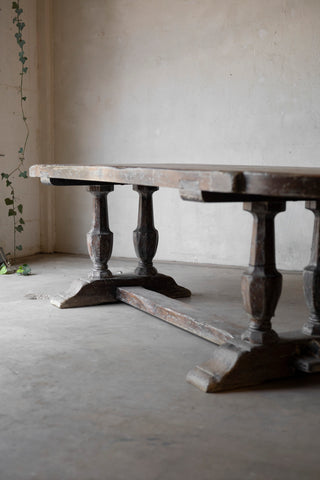 Wooden table with decorative legs in a minimalistic room
