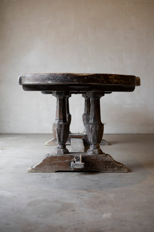 Vintage wooden table with a rustic design on a plain floor and wall background