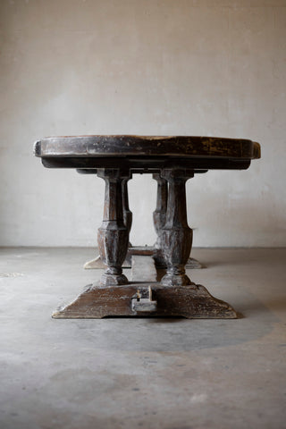 Vintage wooden table with a rustic design on a plain floor and wall background