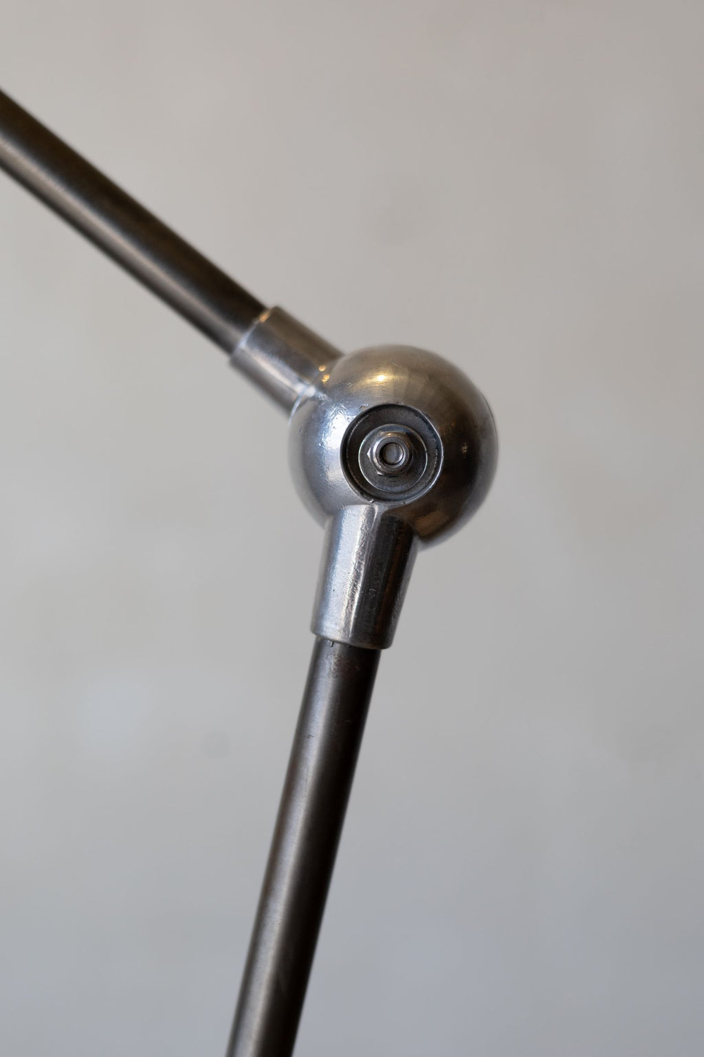 Close up of spherical angle joint of Jielde industrial desk lamp. 