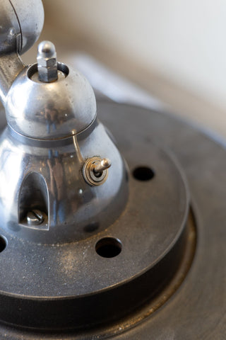 Close up of base of metal Jielde  industrial desk lamp. 