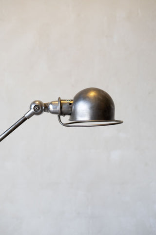 Vintage-style metal wall lamp on a plain background