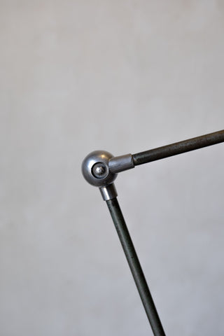 Metal arm with spherical joint on a gray background