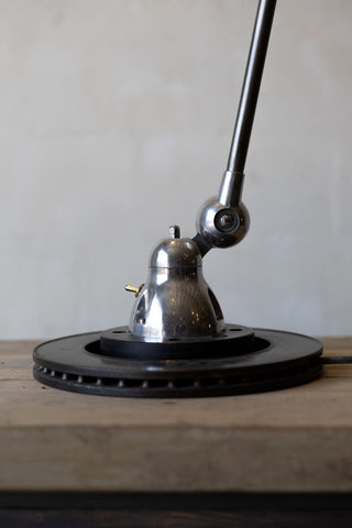 Jielde task lamp base on a wooden surface.