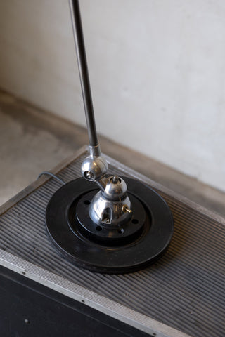 Jielde task lamp black base on a textured surface.