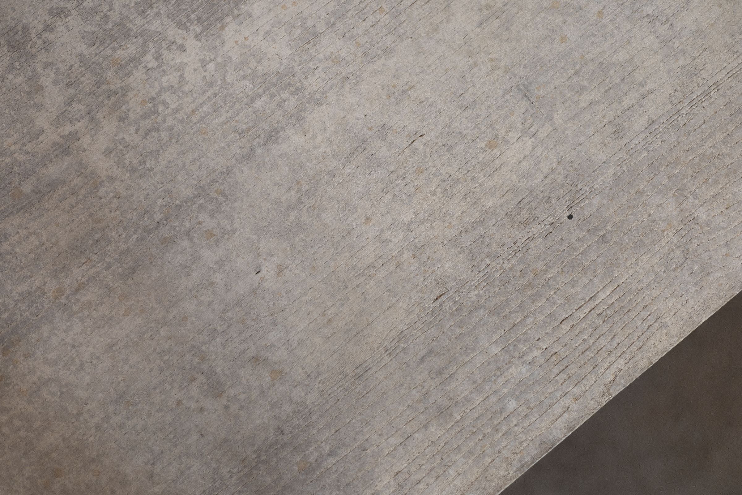 Close-up of a textured wooden surface of trestle table. 