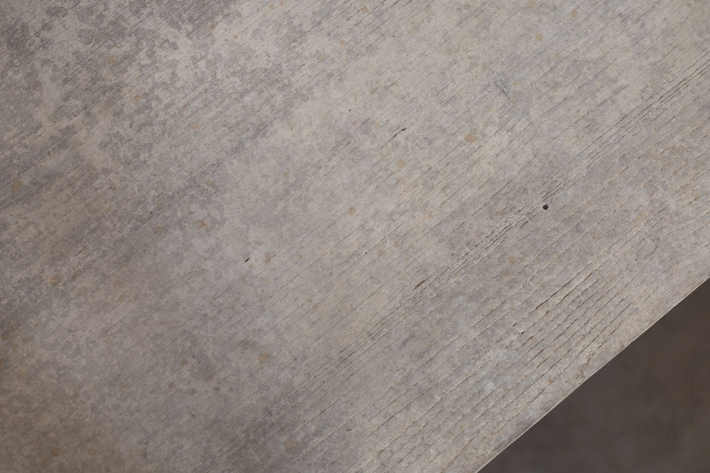 Close-up of a textured wooden surface of trestle table. 