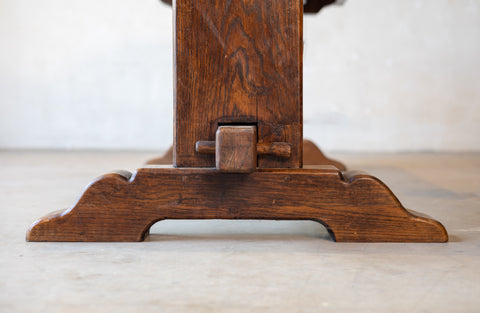 Bottom of a ventage French table featuring double pedestal design with a white background. 