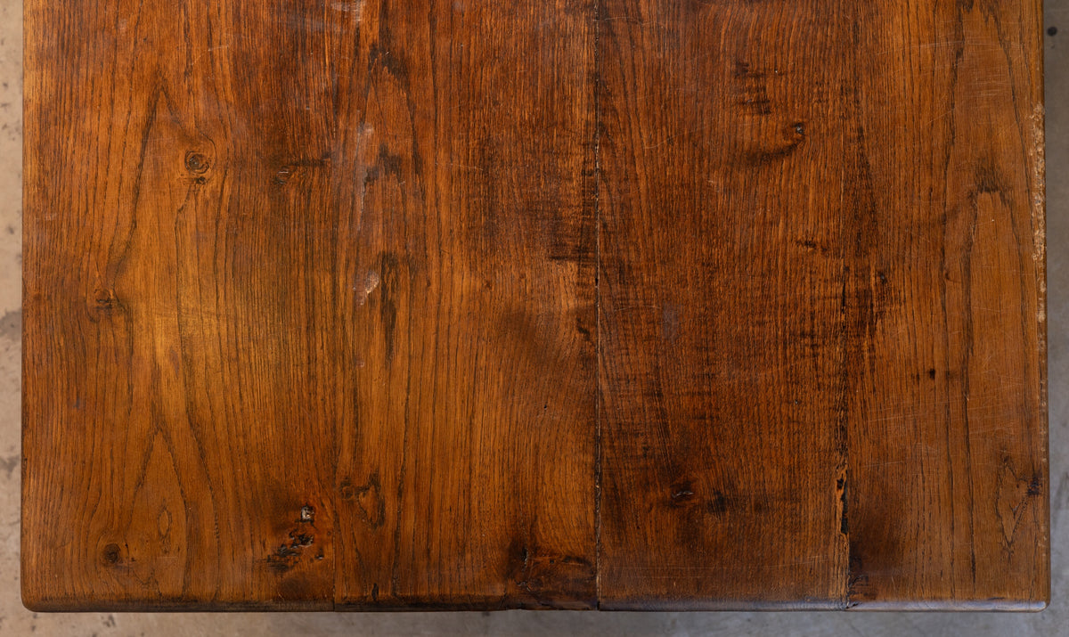 Close-up of a wooden surface with visible grain and texture.