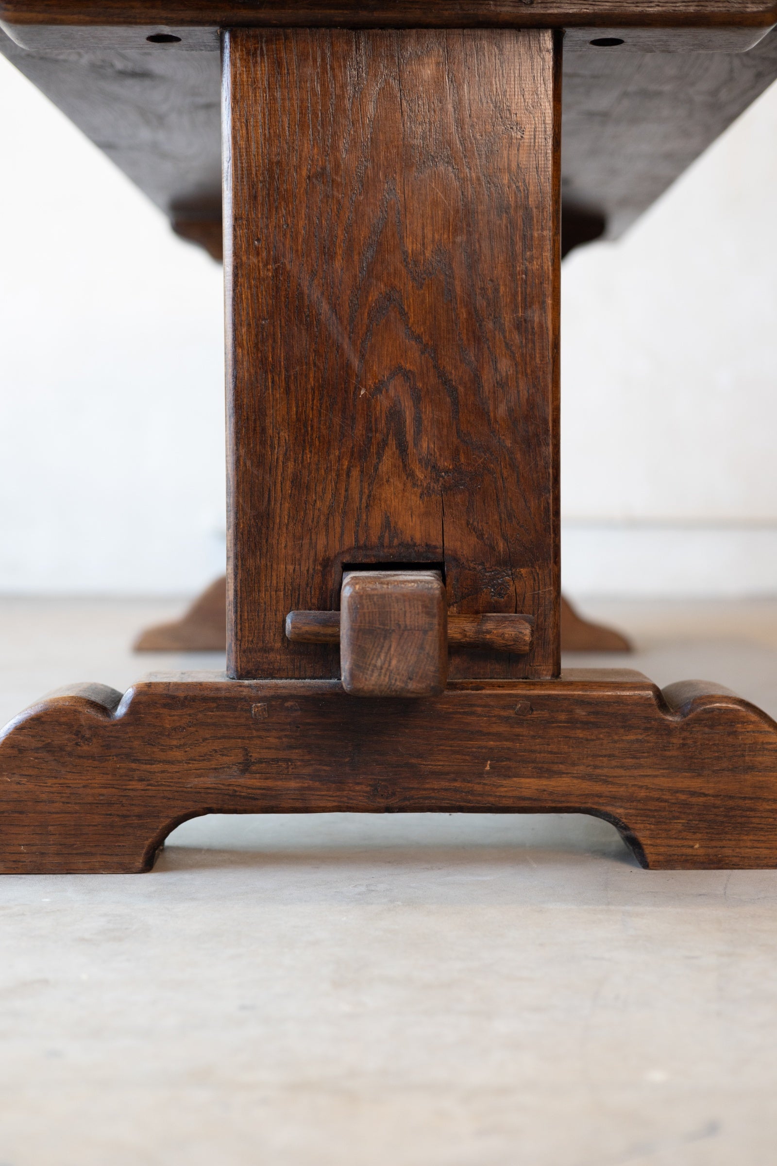 Bottom of a ventage French table featuring double pedestal design with a white background. 