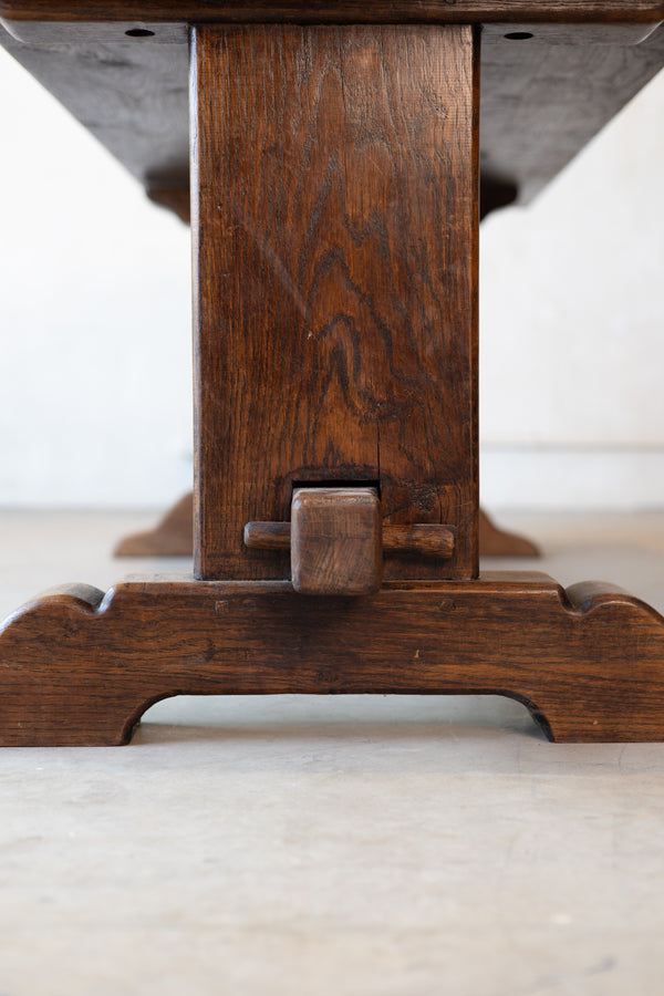 Bottom of a ventage French table featuring double pedestal design with a white background. 