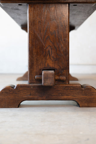 Bottom of a ventage French table featuring double pedestal design with a white background. 