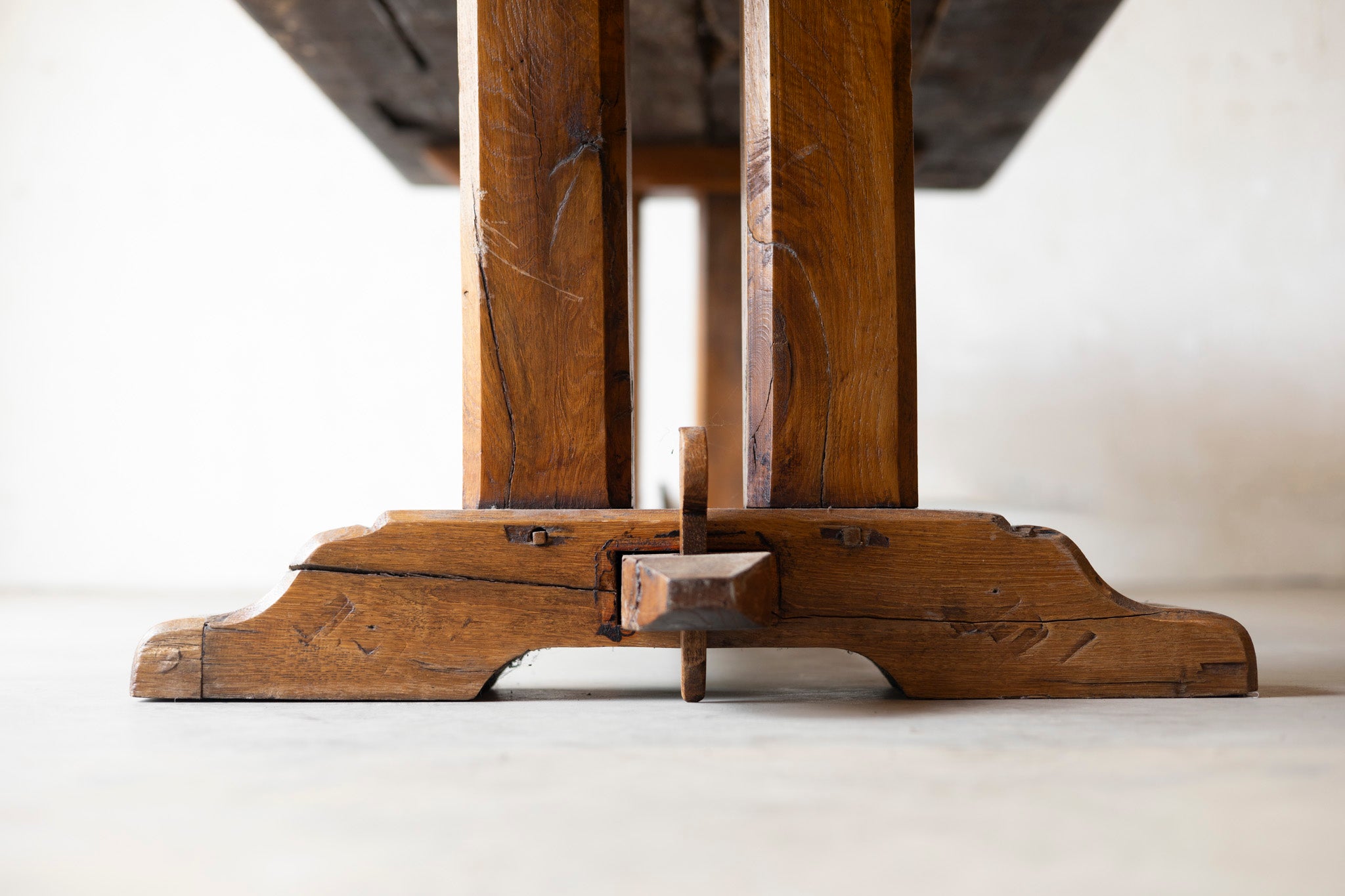 Close-up of a wooden table leg on a white background