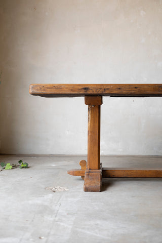 Wooden table against a plain wall