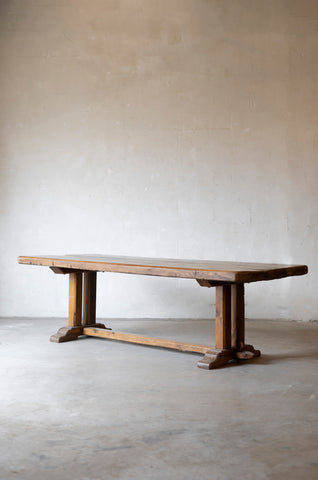 Wooden table against a plain wall