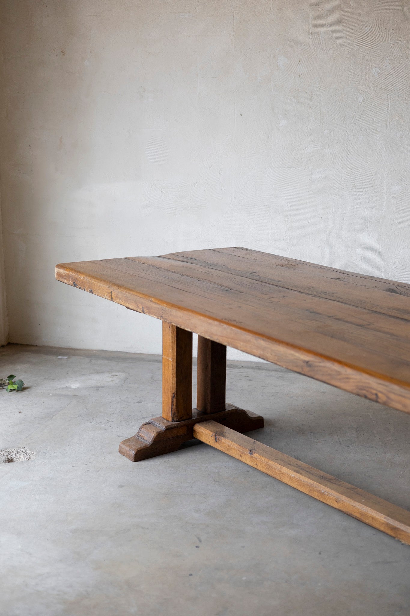 Wooden table with a rustic design in a minimalistic room.