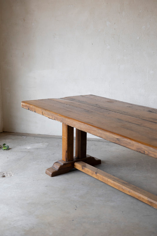 Wooden table with a rustic design in a minimalistic room.