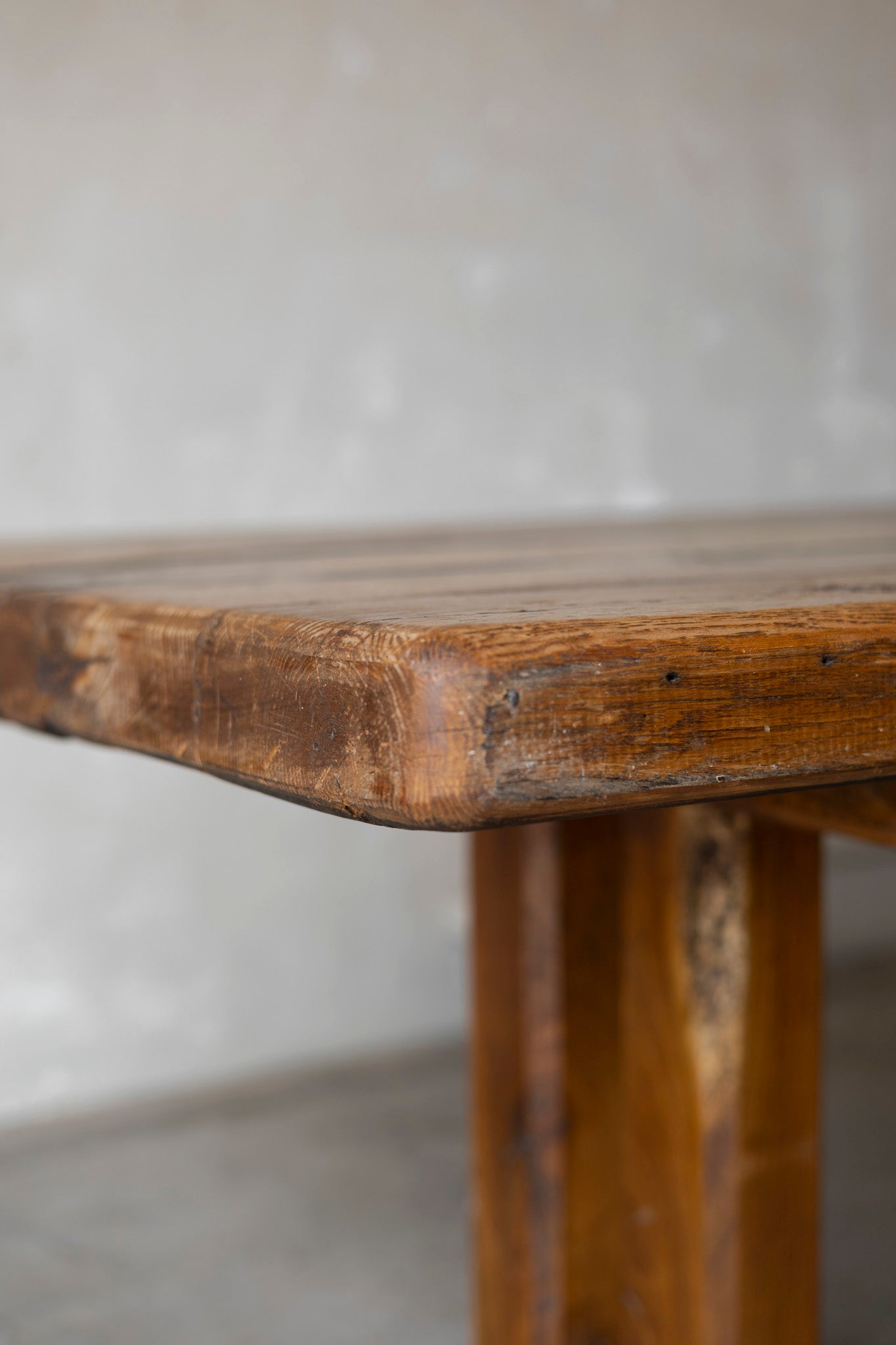 Close-up of a wooden table with a plain background