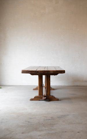 Wooden table against a plain white wall