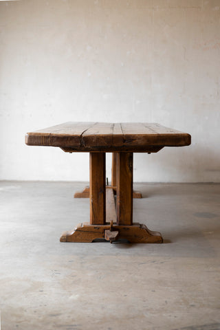 Wooden table with a rustic design on a plain floor and wall background