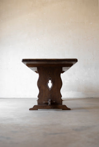 Wooden side table with decorative legs on a plain background
