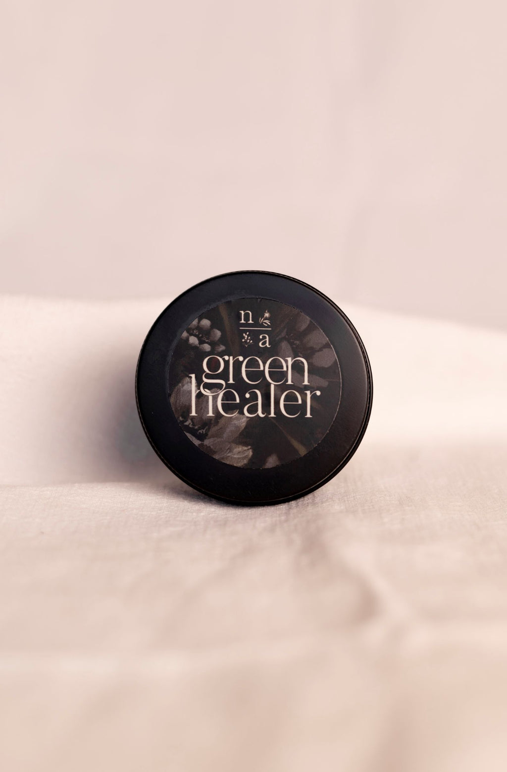 All natural ashe juniper moisturizing balm labeled 'green healer' on a soft white background.