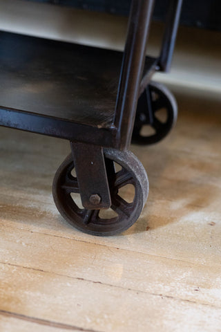Iron bar cart iron speakeasy style wheels.