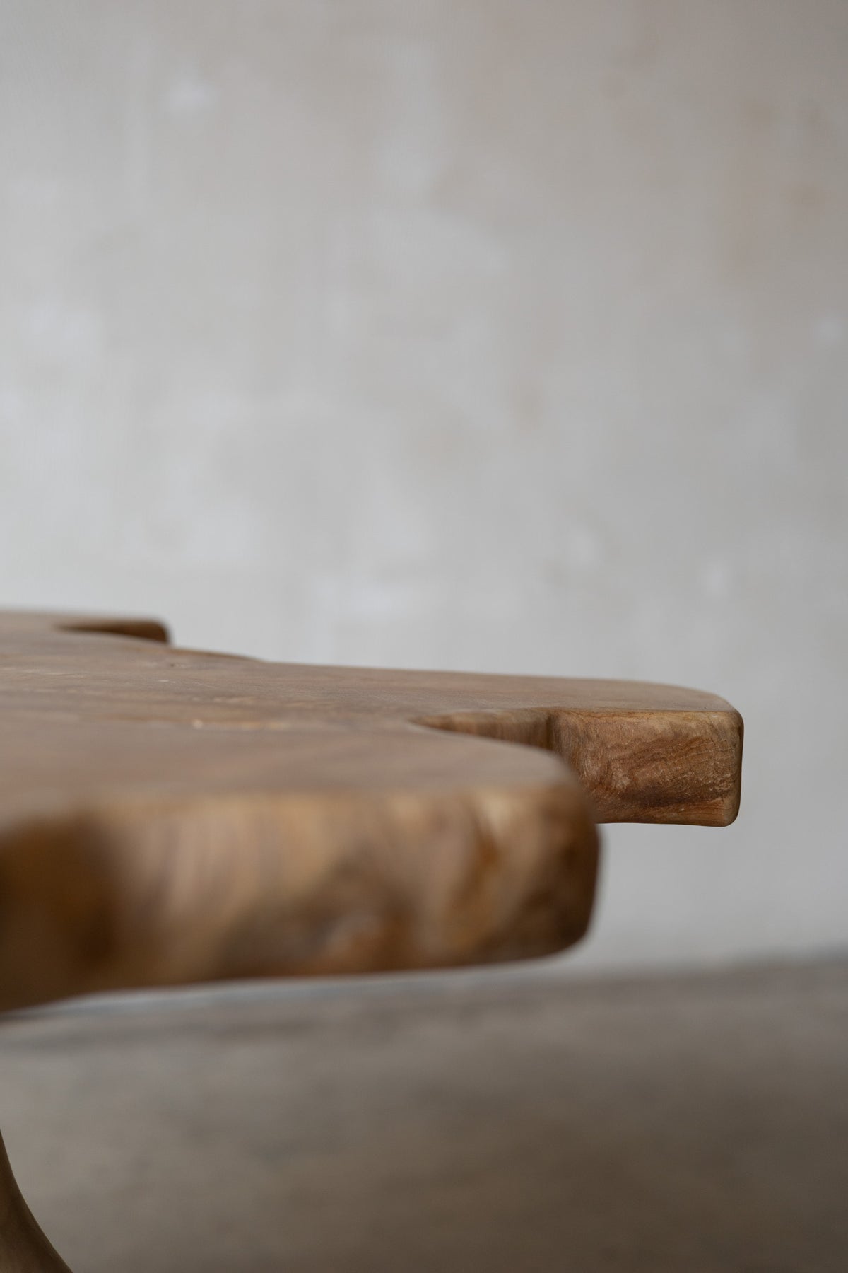 Close-up of a wooden table with a blurred background